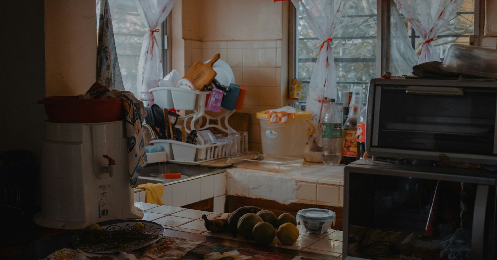 A cluttered kitchen counter with dishes and appliances.